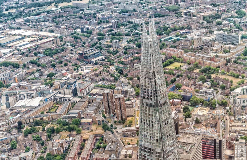 LONDON - JUNE 18, 2015: The Shard and city skyline from helicopter. London attracts 50 million tourists annually