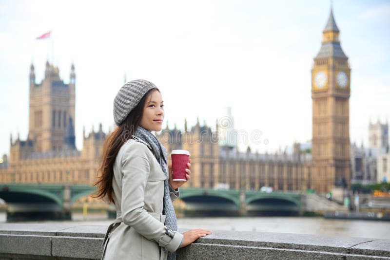 London woman drinking coffee by Westminster Bridge. Young female professional business woman in London, England. Beautiful young multiracial Asian Caucasian girl. London woman drinking coffee by Westminster Bridge. Young female professional business woman in London, England. Beautiful young multiracial Asian Caucasian girl.