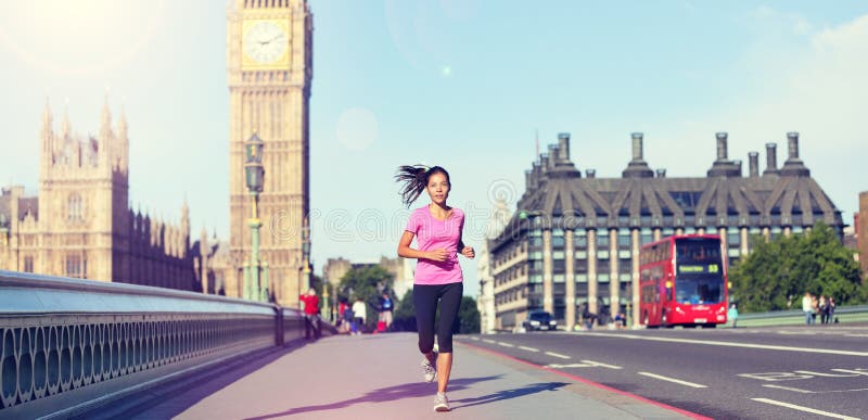 London lifestyle woman running near Big Ben. Female runner jogging training in city with red double decker bus. Fitness girl smiling happy on Westminster Bridge, London, England, United Kingdom. London lifestyle woman running near Big Ben. Female runner jogging training in city with red double decker bus. Fitness girl smiling happy on Westminster Bridge, London, England, United Kingdom.