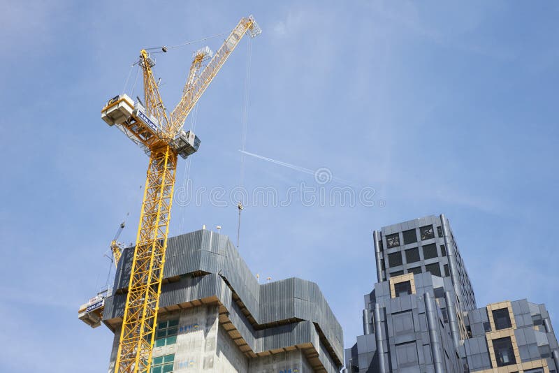 LONDON - MAY, 2017: Crane and modern buildings under construction against blue sky, in the City Of London