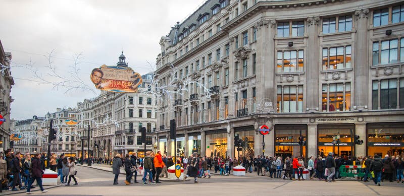 London. Regent street, Oxford circus with lots of pedestrians and cars, taxis on the road.