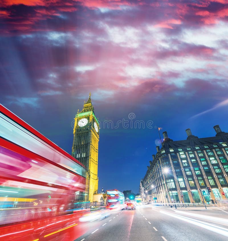 London. City night scene with red bus crossing Westminster. Traffic light trails. London. City night scene with red bus crossing Westminster. Traffic light trails.