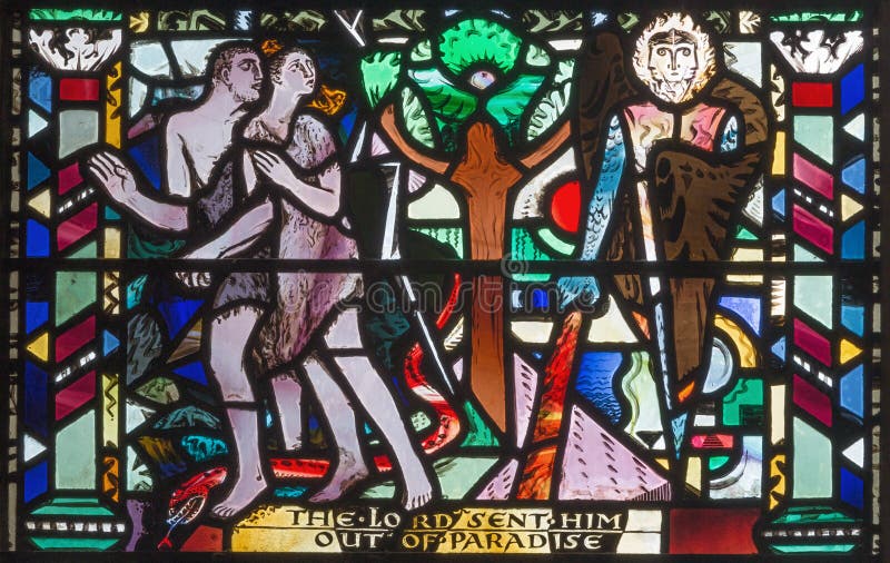 LONDON, GREAT BRITAIN - SEPTEMBER 16, 2017: The Expulsion of Adam and Eve from Paradise on the stained glass in church St Etheldreda by Charles Blakeman 1953 - 1953. LONDON, GREAT BRITAIN - SEPTEMBER 16, 2017: The Expulsion of Adam and Eve from Paradise on the stained glass in church St Etheldreda by Charles Blakeman 1953 - 1953.