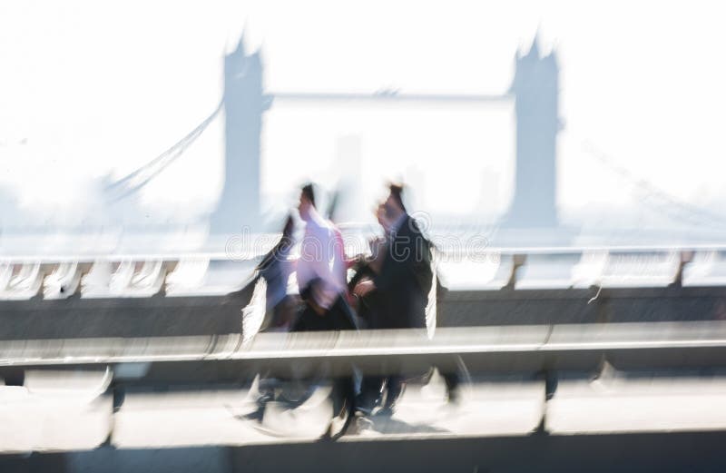 London, UK. Blurred image of Office workers crossing the London bridge in early morning on the way to the City of