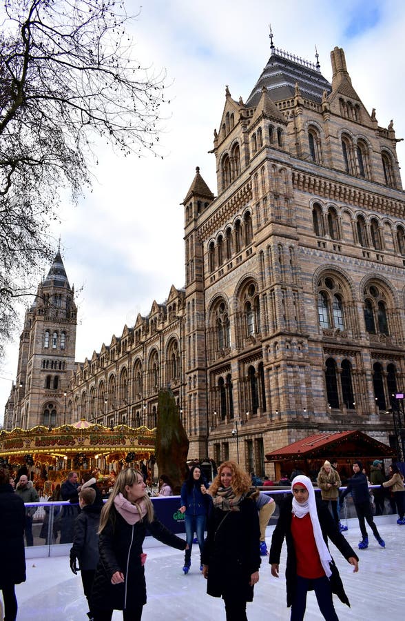 People skating on ice at the Natural History Museum Christmas Ice Rink. London, United Kingdom, January 2019. stock photo People skating on ice at the Natural History Museum Christmas Ice Rink. London, United Kingdom, January 2019. stock photo