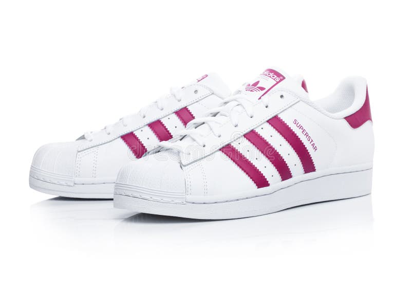 LONDON, UK - JANUARY 12, 2018: Adidas Originals Superstar red shoes on white.German multinational corporation that designs and man royalty free stock images LONDON, UK - JANUARY 12, 2018: Adidas Originals Superstar red shoes on white.German multinational corporation that designs and man royalty free stock images