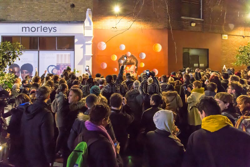 LONDON, UK - JANUARY 11TH 2016: Fans paying tribute to David Bowie after his death stock photo LONDON, UK - JANUARY 11TH 2016: Fans paying tribute to David Bowie after his death stock photo