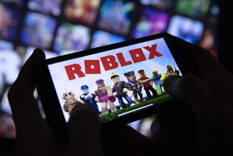 Roblox is an online game platform and game creation system. A smartphone  with the Roblox logo on the screen on the pile of the gamepads Stock Photo  - Alamy