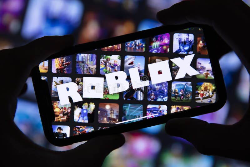 Person holding smartphone with website of US video games company Roblox  Corporation on screen in front of logo. Focus on center of phone display  Stock Photo - Alamy