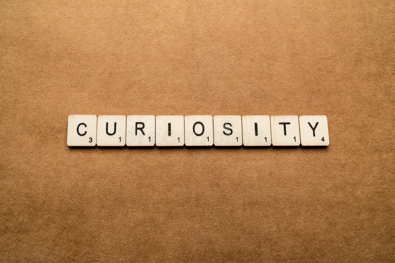 LONDON, UK - May 24 2019: The word CURIOSITY, spelt with wooden letter tiles over a brown textured background royalty free stock images LONDON, UK - May 24 2019: The word CURIOSITY, spelt with wooden letter tiles over a brown textured background royalty free stock images