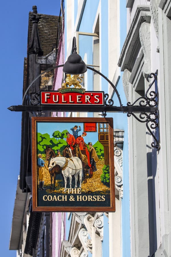 The Coach and Horses Public House in Soho, London. London, UK - 8th March 2022: The traditional hanging pub sign on the exterior of The Coach and Horses public