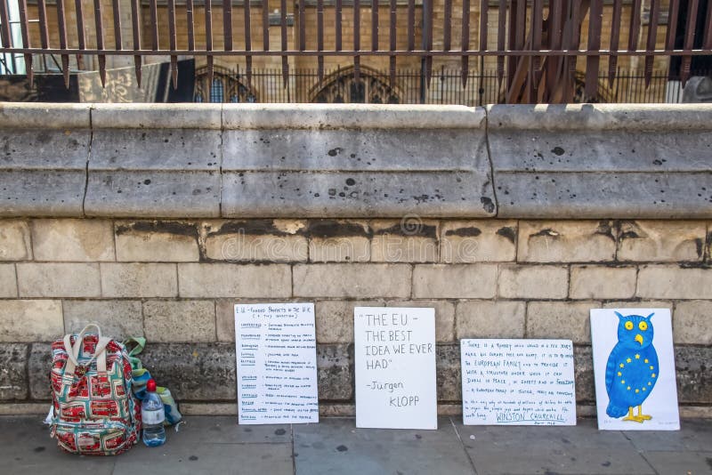 London UK 7 24 2019 Anti Brexit Pro EU signs on sidewalk with backpack and water nearby. London UK 7 24 2019 Anti Brexit Pro EU signs on sidewalk with backpack and water nearby.