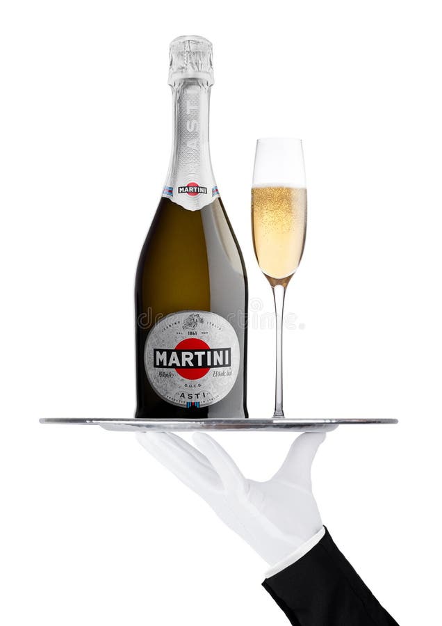 LONDRES, R-U - 24 novembre 2017 : La main avec le gant tient le plateau avec la bouteille et le verre de champagne de Martini Ast image libre de droits LONDRES, R-U - 24 novembre 2017 : La main avec le gant tient le plateau avec la bouteille et le verre de champagne de Martini Ast image libre de droits