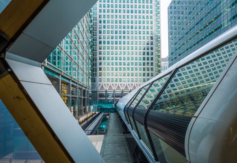 London, England - Public pedestrian cross rail footbridge at the financial district of Canary Wharf with skyscrapers. London, England - Public pedestrian cross rail footbridge at the financial district of Canary Wharf with skyscrapers