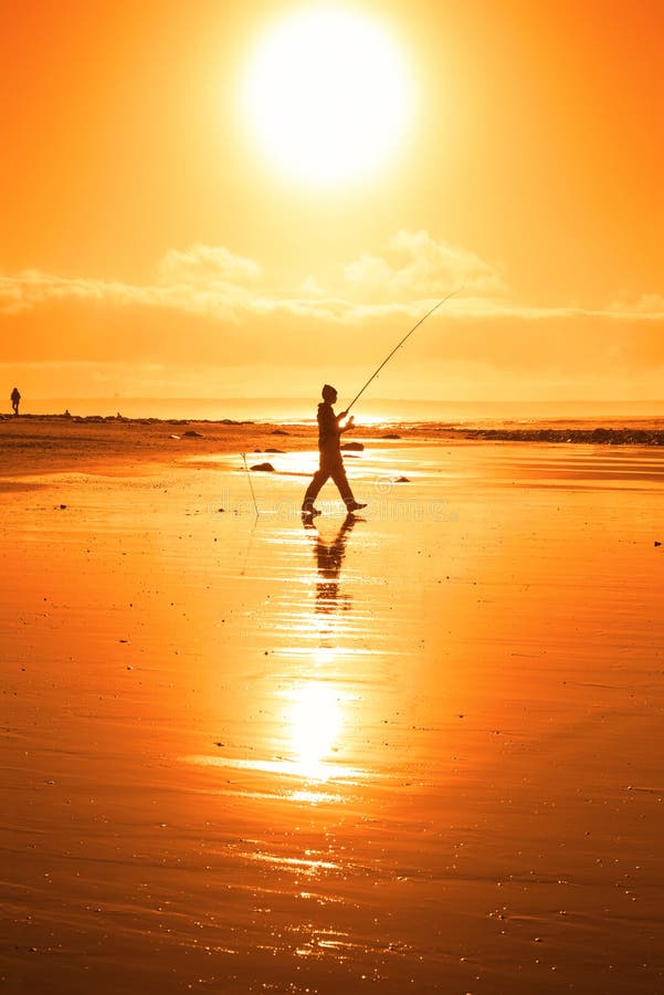 Lone fisherman fishing on the Kerry beach royalty free stock photography Lone fisherman fishing on the Kerry beach royalty free stock photography