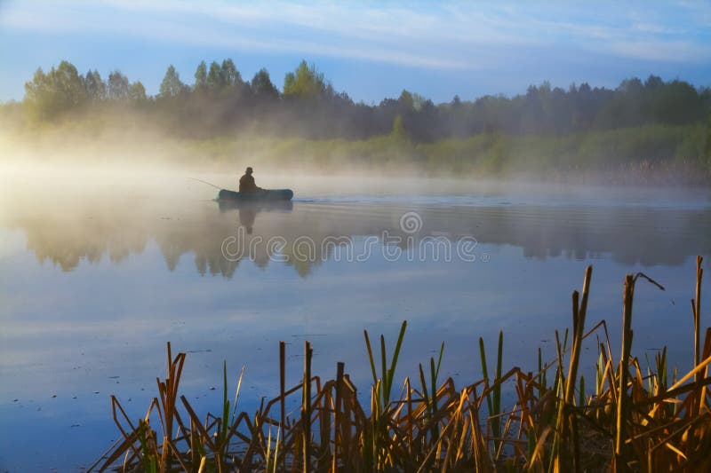 Fisherman on the lake near Pskov city early in the morning. Fisherman on the lake near Pskov city early in the morning