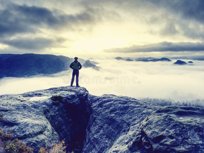 Lone male hiker looks out over high mountains and valley royalty free stock photography Lone male hiker looks out over high mountains and valley royalty free stock photography