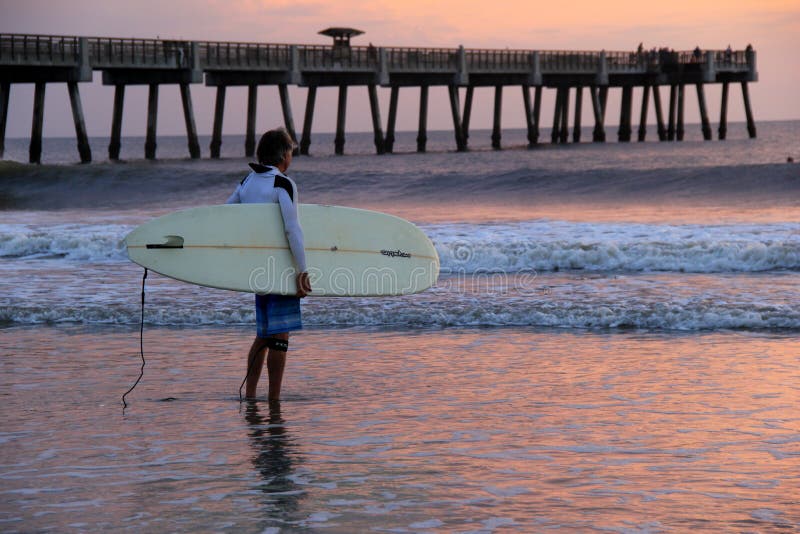 Lone surfer standing in the surf on a gorgeous morning,Jacksonville Beach,Florida,2015