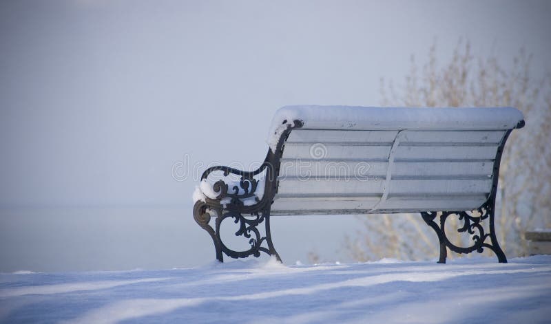 Snowed bench with view on the sea. Snowed bench with view on the sea