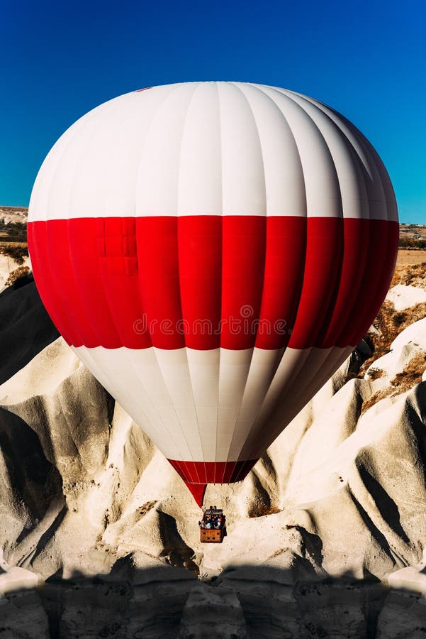 A lonely balloon in the sky above the mountains. Balloons in the sky over Cappadocia at sunrise. Colorful hot air balloon moving stock photography A lonely balloon in the sky above the mountains. Balloons in the sky over Cappadocia at sunrise. Colorful hot air balloon moving stock photography