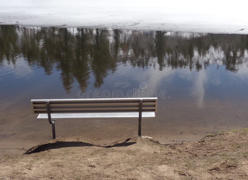 Lonely Bench on Frozen Winter Lakeside stock photos Lonely Bench on Frozen Winter Lakeside stock photos