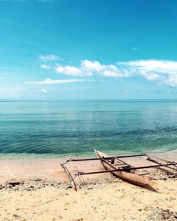 Lonely Boat on an Isolated Beach in Raja Ampat, West Papua, Indonesia