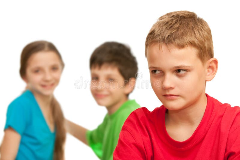 A boring kid is sitting against his happy friends; isolated on the white background. Boring kid white stock images, royalty-free photos and pictures