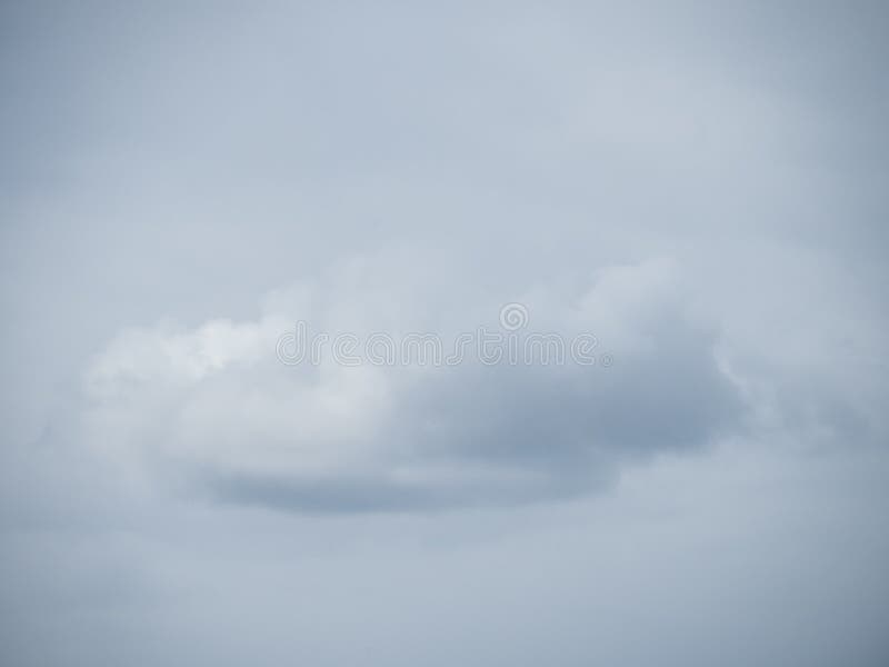 Lonely cloud before a cloudy sky stock photography