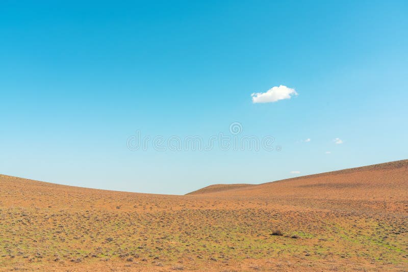 Lonely cloud over mountain meadow stock photography