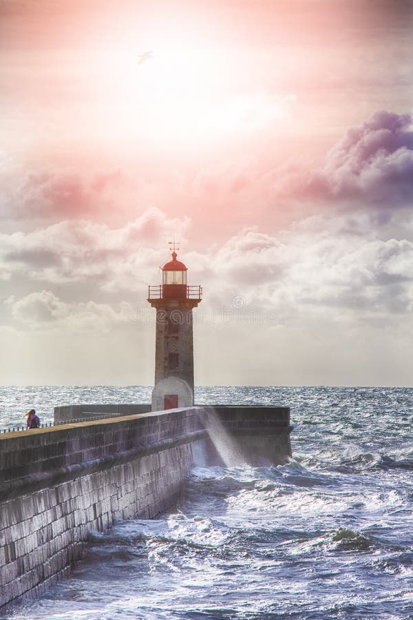 Lonely Lighthouse on the Pier in Porto City in Portugal Against Roaring Ocean stock photos Lonely Lighthouse on the Pier in Porto City in Portugal Against Roaring Ocean stock photos