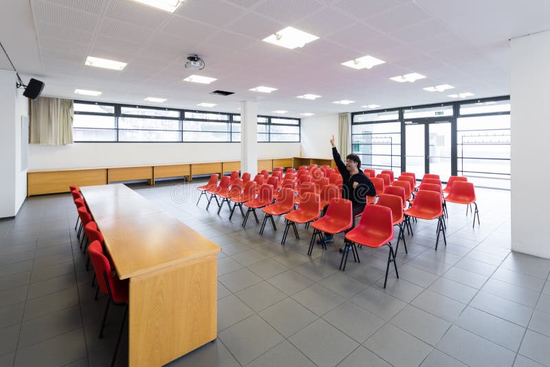 Lonely man in empty conference room, concept stock photography Lonely man in empty conference room, concept stock photography