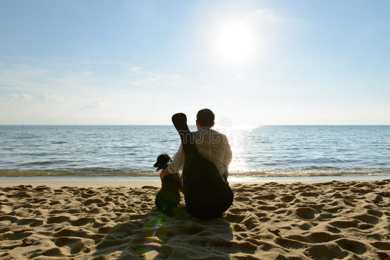 Lonely man with dog and guitar stock photo Lonely man with dog and guitar stock photo