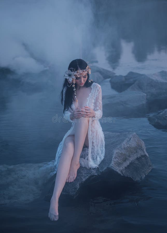 A lonely mermaid, sitting on a rock in the middle of the river, which was tightened by a thick, impenetrable fog. On the sea nymph a white vintage dress with bare legs and a wreath of shells.