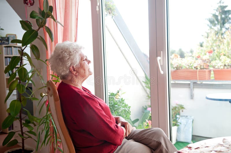 Lonely old woman looks out the window. Old granny stock images, royalty-free photos and pictures