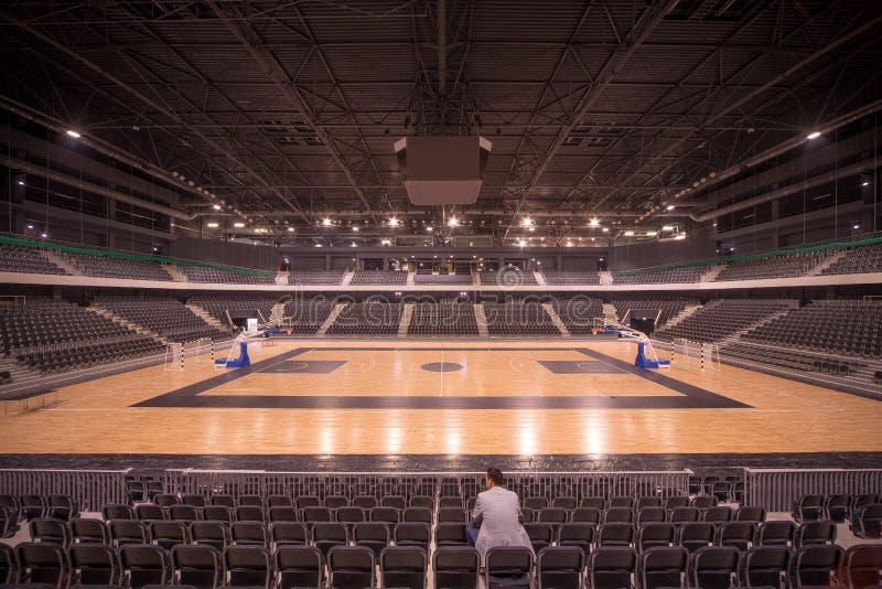 Lonely spectator in sports hall