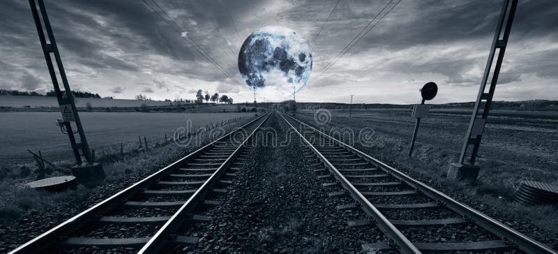 Lonely train track and a surreal full moon