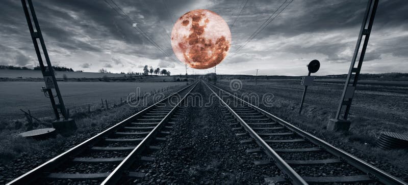 Lonely train track and a surreal full moon