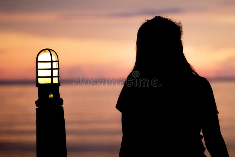 Photo of silhouette adult woman in profile on twilight background. Lonely  woman standing alone moments sunset. Style abstract shadows. Let's Stay  Toge Stock Photo - Alamy