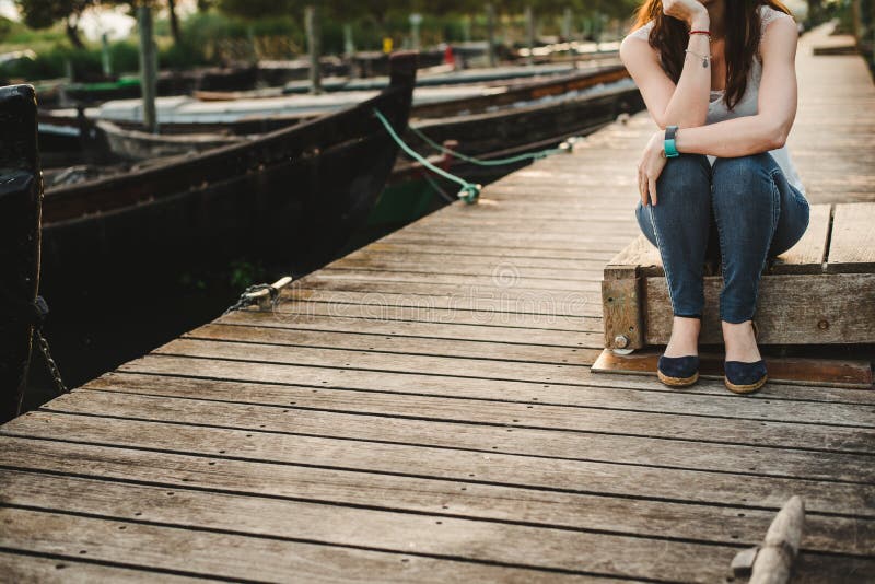 Lonely woman waiting on the dock