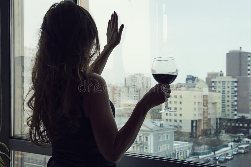 Lonely young woman at home drinking alcohol. Female alcoholism. single luxury beautiful woman in black dress with wine stock photo Lonely young woman at home drinking alcohol. Female alcoholism. single luxury beautiful woman in black dress with wine stock photo