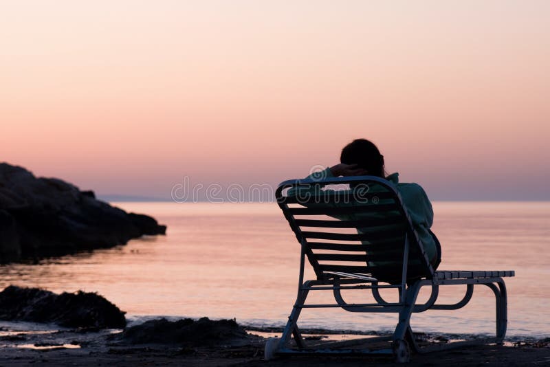 Lonely young woman near the ocean royalty free stock photos