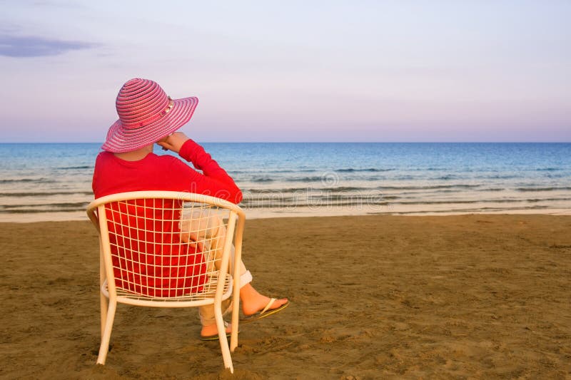 Lonely young woman near the ocean stock image