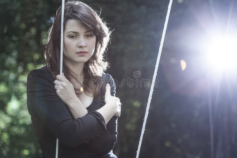 Lonely young woman in sorrow stock images
