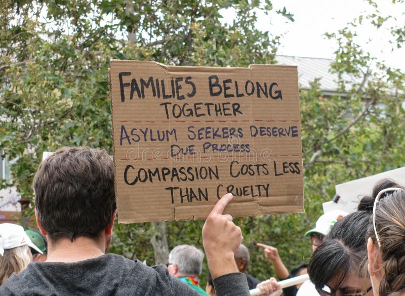 Long Beach, California USAâ€“June 30, 2018: At a Keep Families Together march, a sign urges due process and compassion for asylum seekers forced to flee their countries. Long Beach, California USAâ€“June 30, 2018: At a Keep Families Together march, a sign urges due process and compassion for asylum seekers forced to flee their countries.