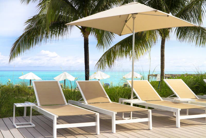 Long chairs near the piscine in a resort in Bahamas