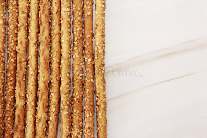 Long Dry Sesame Bread Sticks on Marble Background Stock Photo Image