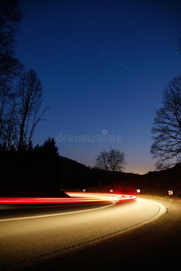 Long Exposure of Front and Rear Light Trails of a Moving Car on a