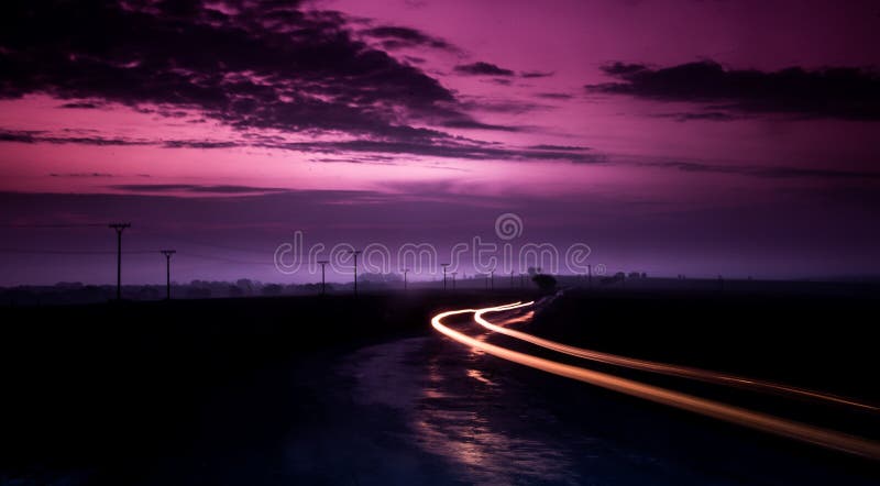 Long exposure image of a cars passing on a mountain road