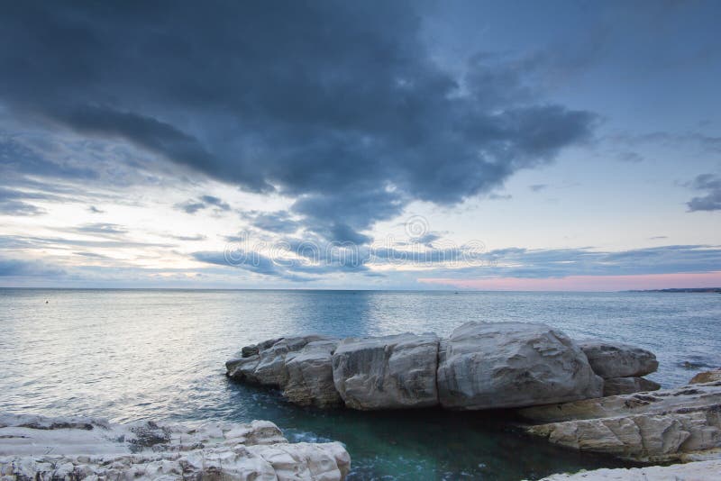 Long exposure shot of clouds passing by on the rocks royalty free stock photography