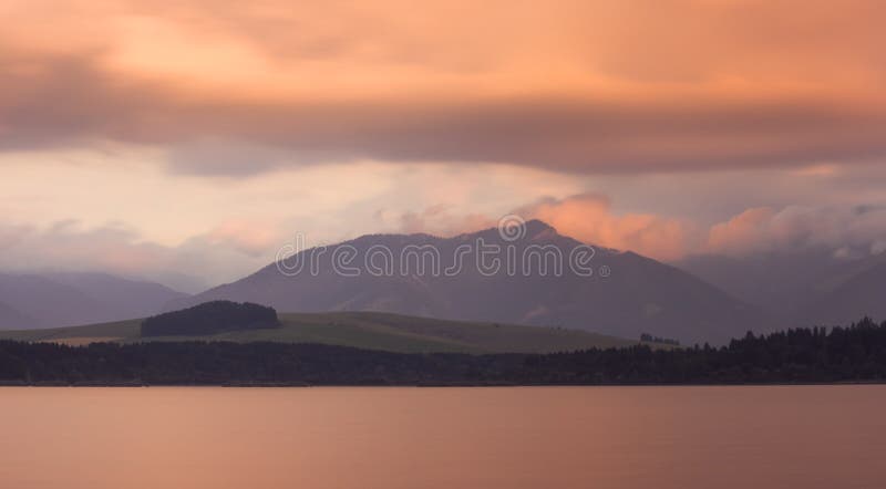 Long Exposure Shot of Lake, Mountains and Cloudy Sky